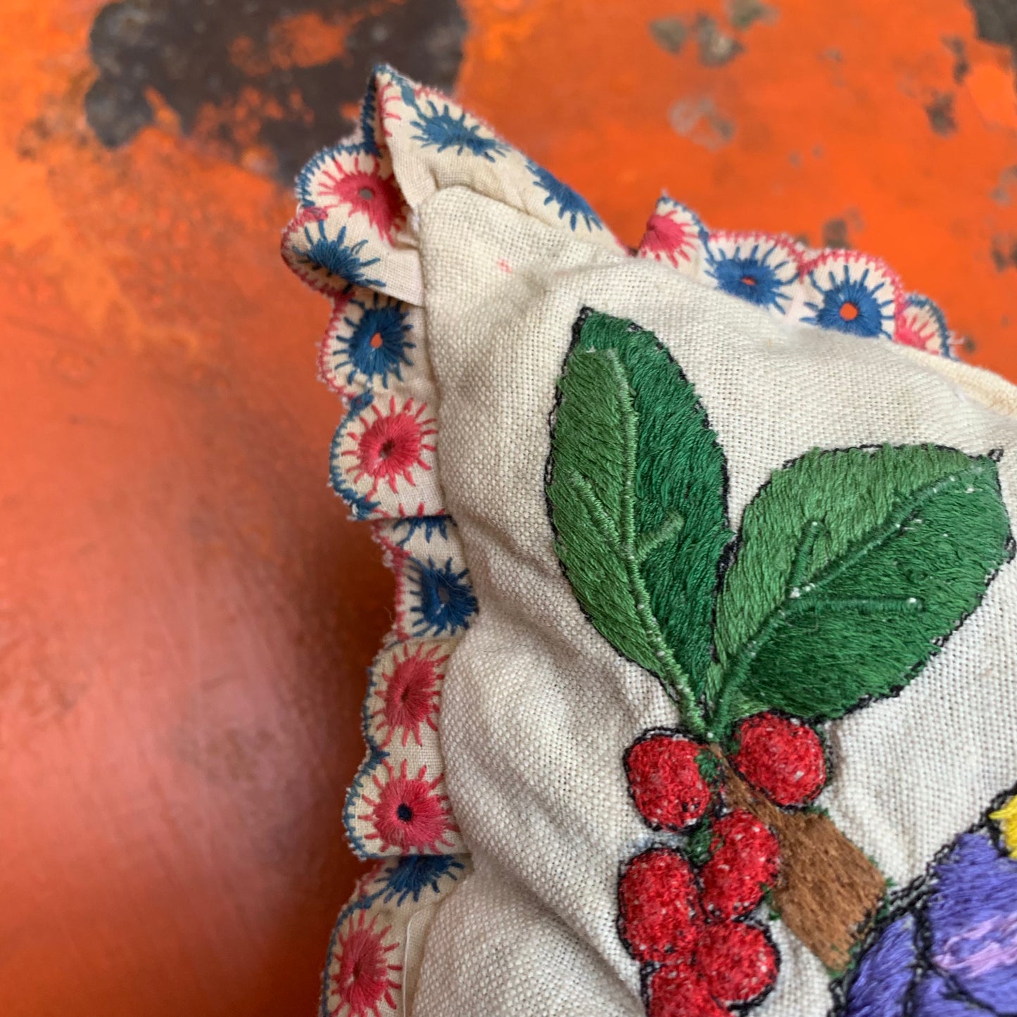 Embroidered pillow with parrot