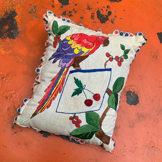 Embroidered pillow with parrot