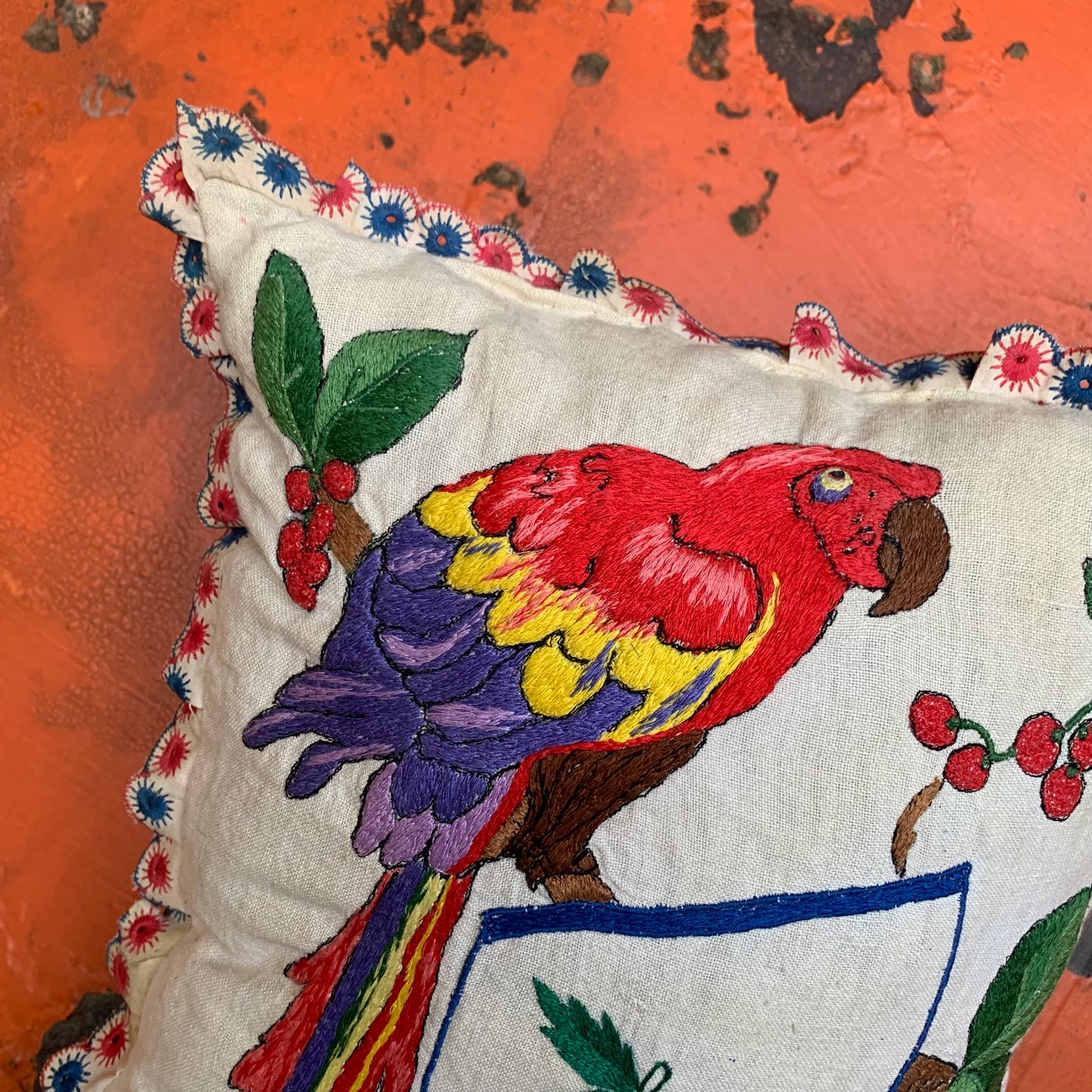 Embroidered pillow with parrot
